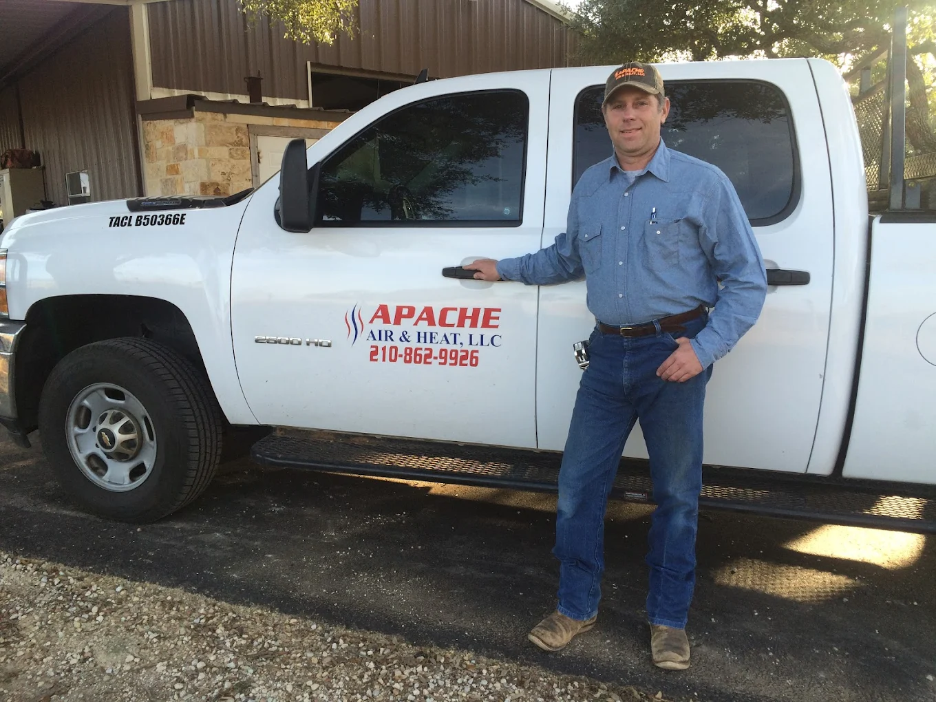 Apache Air & Heat HVAC technician standing beside service truck in Blanco TX