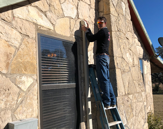 AC Repair Services in Blanco TX | Apache Air & Heat HVAC technician performing air conditioning repair service in Blanco, TX for Apache Air & Heat.