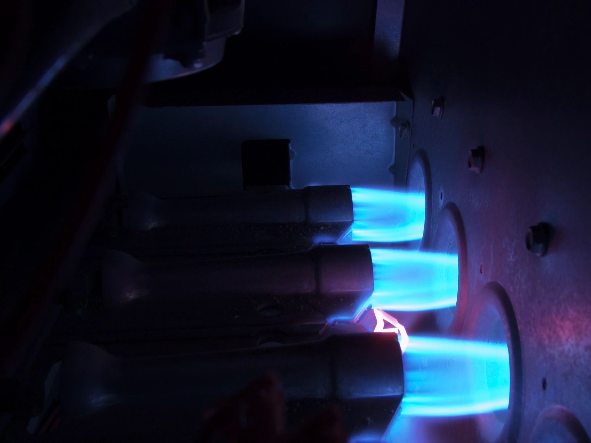Blue furnace burner flame inside a high-efficiency heating system in Blanco, TX